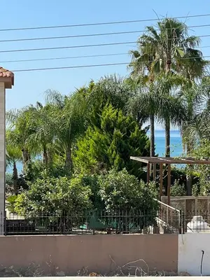 a view of the beach from a house with palm trees at Villa Scarlett, Ayia Thekla in Ayia Napa