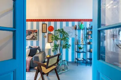 a living room with blue and white striped walls at Blue Haven - 2-BR Artistic Escape in Larnaca in Larnaka