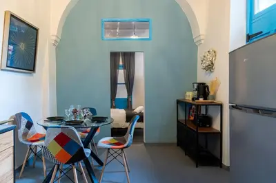 a dining room with a table and chairs at Blue Haven - 2-BR Artistic Escape in Larnaca in Larnaka
