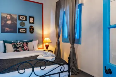 a bedroom with a bed with blue walls and a window at Blue Haven - 2-BR Artistic Escape in Larnaca in Larnaka