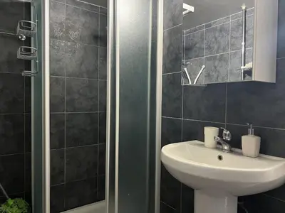 a bathroom with a sink and a shower at two-room apartment center in Limassol