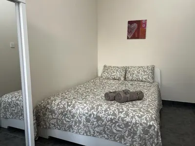 a bedroom with a bed with a bag on it at two-room apartment center in Limassol