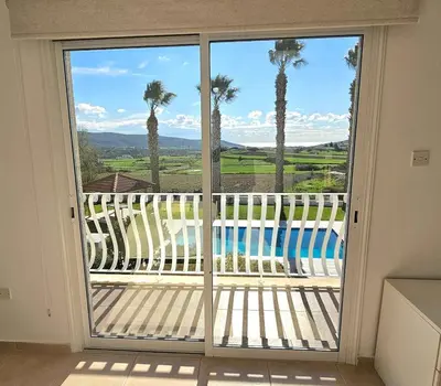 a sliding glass door with a view of a pool at White Cove Villa, Limassol in Pyrgos