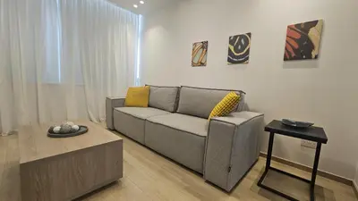 a living room with a couch and a table at STAY City Center Gem in Nicosia