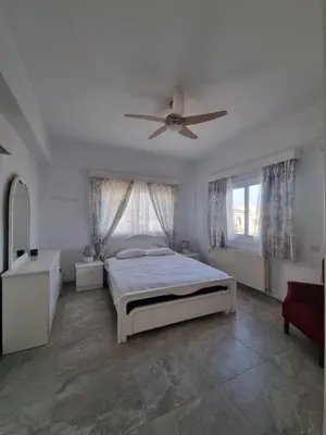 a bedroom with a bed and a ceiling fan at Jacobs home in Larnaka