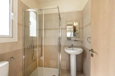 a bathroom with a shower and a sink at Protaras Villa Cemelia in Protaras