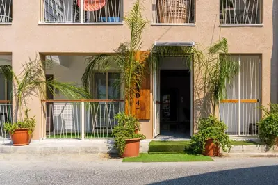 a building with potted plants in front of a door at Marble - Cozy Studio W Balcony in Larnaca in Larnaka