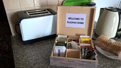 a welcome to beans house box next to a toaster at Elenas Home in Limassol