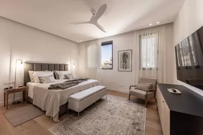 a bedroom with a bed and a ceiling fan at Elysium Heights in Nicosia