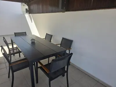 a black table and chairs in a room at Urban Condo 33 with Balcony - 2 Bdr in Nicosia