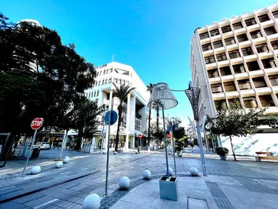 a city street with sculptures of balls on the street at Urban Condo 33 with Balcony - 2 Bdr in Nicosia
