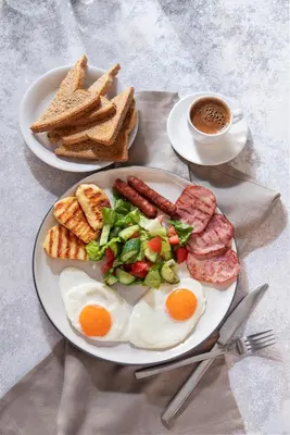 a plate of breakfast food with eggs sausage and toast at Urban Condo 33 with Balcony - 2 Bdr in Nicosia