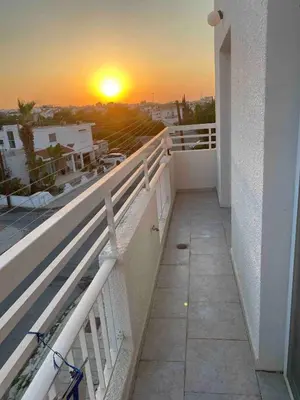 a balcony with a sunset on the horizon at Lovely Paradise - 1-bd apt in Kapparis - Protaras in Paralimni