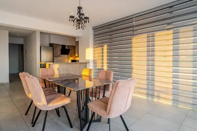 a dining room with a table and chairs at Penthouse Great View Hydromassage Penthouse hottub in Limassol