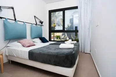 a bedroom with a bed with two towels on it at WealthyStays 2BR Retreat , 5Min Walk to Beach in Protaras