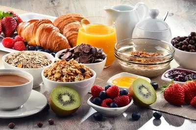 a breakfast table with breakfast foods and fruits and juice at Eat well Sleep Well in Larnaka