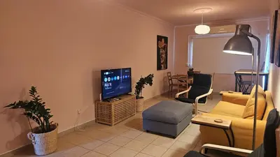 a living room with a couch and a television at STAY Velvet Apartment in Limassol