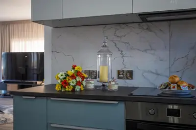a kitchen with a counter with flowers and a blender at Perle Di Gio in Larnaka