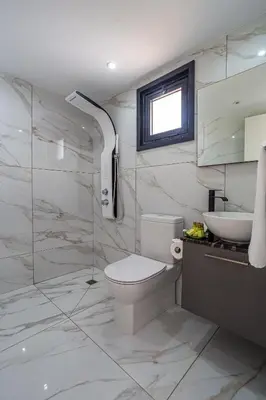 a bathroom with a toilet and a sink and a shower at Perle Di Gio in Larnaka