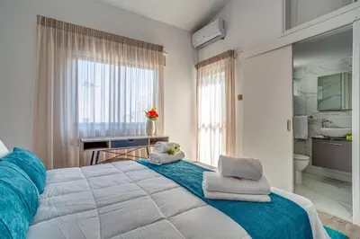 a bedroom with a large bed with towels on it at Perle Di Gio in Larnaka