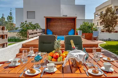 a wooden table with a bowl of fruit on it at Perle Di Gio in Larnaka