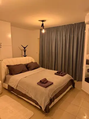 a bedroom with a large bed with towels on it at FLH - Feel Like Home Modern 1-Bedroom Ground floor Apartment in Strovolos in Kato Lakatamia