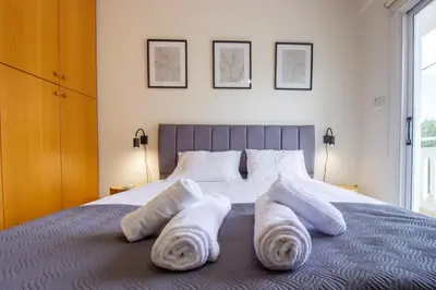 a bedroom with white towels on a bed at Central & Peaceful Nicosia 2BR in Nicosia