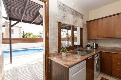 a kitchen with a sink and a swimming pool at Malama 28 Villa Ekaterina in Paralimni