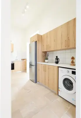 a kitchen with a refrigerator and a washing machine at Lito - Slow Living in Larnaka