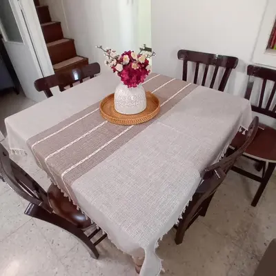 a white table with a vase of flowers on it at En Sylikion cottage in Silikou