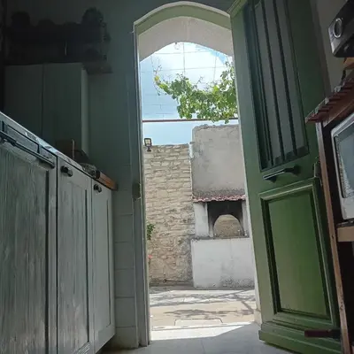 an open door to a room with a brick oven at En Sylikion cottage in Silikou