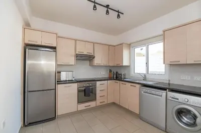 a kitchen with a stainless steel refrigerator and a dishwasher at Pernera Gardens Villa Ekaterina in Protaras