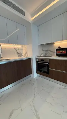 a kitchen with marble counter tops and a sink at Luxury Apartments with Sea View and Mountain View in Grand Sapphire Resort in Iskele