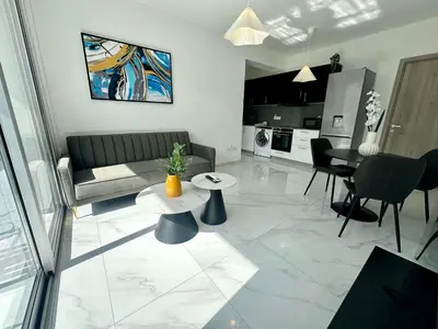 a living room with a couch and a table at New 1 bedroom flat in Aglatzia in Aglantzia