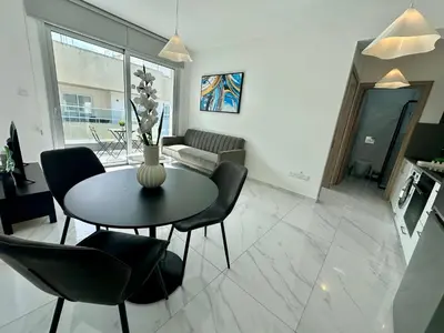 a living room with a table and chairs at New 1 bedroom flat in Aglatzia in Aglantzia