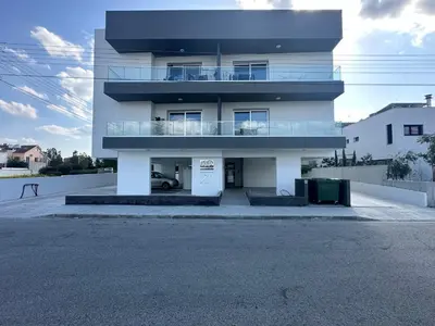 a large white building with a parking lot at New 1 bedroom flat in Aglatzia in Aglantzia