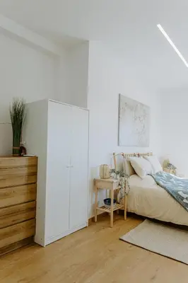 a white bedroom with a bed and a desk at Stylish Stonehouse in Platres in Platres