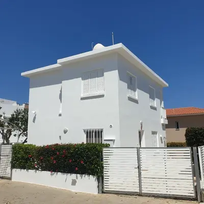 a white house with a fence in front of it at SWeET LEMON VILLA in Protaras