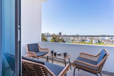 a balcony with chairs and a table with a view at Olympus 2-Bedroom Apartment in Larnaka