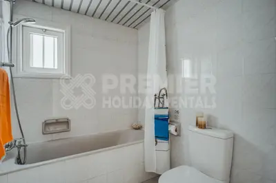 a bathroom with a toilet and a tub and a shower at Villa Andreas in Protaras