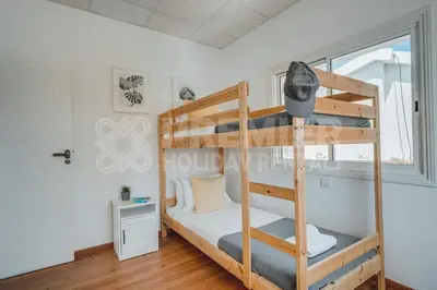 a bedroom with a bunk bed with a ladder at Villa Andreas in Protaras