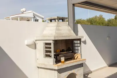 a brick oven on the side of a house at Villa Antonieta in Ayia Napa