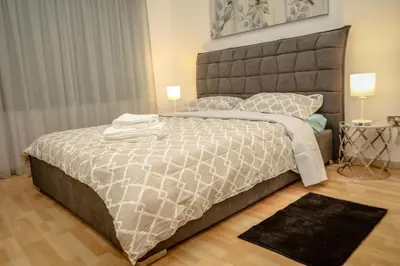 a bedroom with a large bed and two lamps at Seaway moments in Limassol