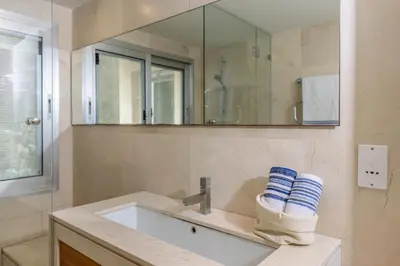 a bathroom with a sink and a mirror at 3BR Beachfront Gem in Limassol in Limassol
