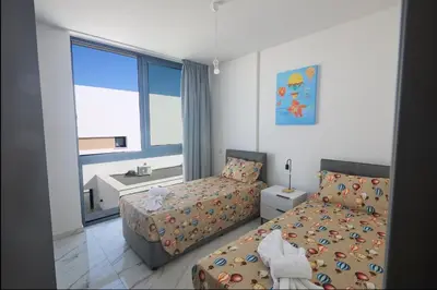 a bedroom with two beds and a window at Protaras Aqua Pearl Villa AQ12 in Paralimni