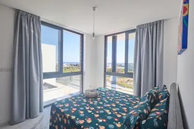 a living room with a couch and a large window at Protaras Aqua Pearl Villa AQ12 in Paralimni