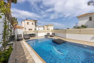 a swimming pool in the backyard of a house at Villa Protaras View 6 Central Protaras -Fig Tree Bay-Jacuzzi-Hot Tub in Protaras