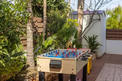 a table with a board game in a garden at Villa Protaras View 9 Central Protaras -Fig Tree Bay-Jacuzzi-Hot Tub in Protaras