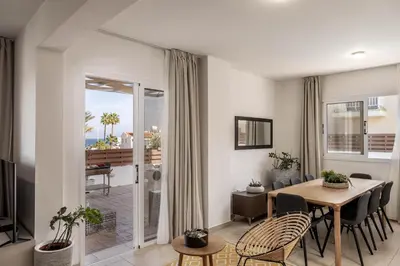 a living room with a dining room table with chairs at Villa Protaras View 9 Central Protaras -Fig Tree Bay-Jacuzzi-Hot Tub in Protaras