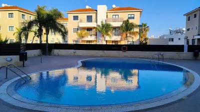 a large blue swimming pool with buildings in the background at Déjà Blue Apartment Kyklades BC7 - workspace, pool, gym, nearby beach in Protaras